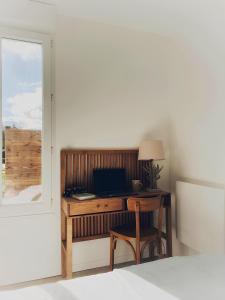 un escritorio con un ordenador portátil junto a una ventana en La Vie En Gîte (Le Cosy), en Sainte-Florence