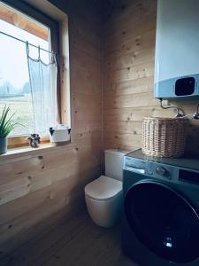 a small bathroom with a toilet and a window at Babiogórskie klimaty in Zawoja