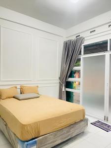 a bedroom with a bed and a large window at Minamo Homestay Modern Tengah Kota Payakumbuh in Payakumbuh +17 photos