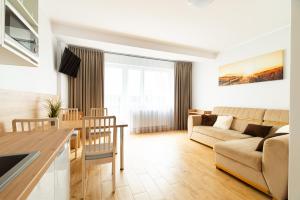 a living room with a couch and a table at Willa Karol in Karwia