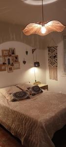 a bedroom with a bed with two pillows on it at Le Petit Patio in Aigues-Mortes