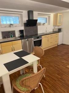 a kitchen with a table and a table and chairs at Gästehaus Brunswiek Studio in Vordorf +32 photos