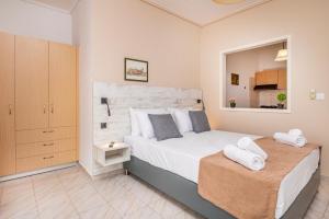 a bedroom with a large white bed and a mirror at City Life Marina apartment No. 5 in Ampavris