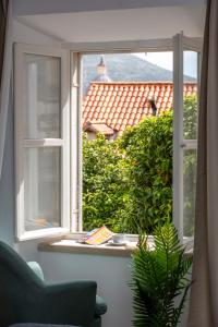 an open window with a view of a house at Sounds of Ragusa in Dubrovnik