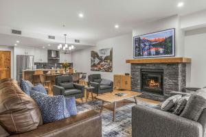 a living room with couches and a fireplace at Brand New - TimberLodge Spacious 2br in Canmore