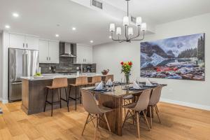a kitchen and dining room with a table and chairs at Brand New - TimberLodge Spacious 2br in Canmore