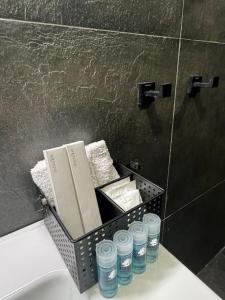 a basket of towels and water bottles in a bathroom at The Loft. Gerakas. in Athens +61 photos