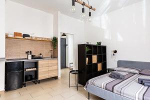 a bedroom with a bed and a sink and a kitchen at La Piazzetta in Piacenza