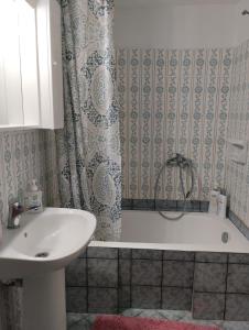 a bathroom with a tub and a sink and a shower at Εξοχική κατοικία Αnna's house 
