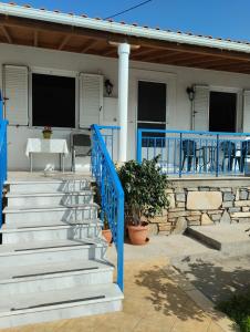 a set of stairs leading to a house with blue railing at Εξοχική κατοικία Αnna's house 