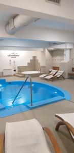 a large blue swimming pool in a building at Mediterráneo Hotel y Spa in Rosario