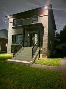 a brick building with a staircase in front of it at Confort All Private in Longueuil