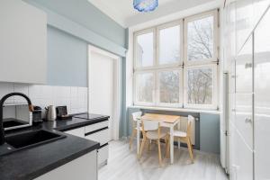a kitchen with a table and chairs in it at Erasmus Student Apartments - Old Town in Kraków