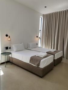 a bedroom with a large bed and a table at Dzixile in Gueima