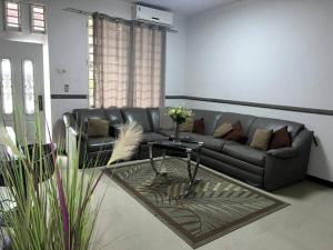 a living room with a couch and a table at Luxurious house in Paramaribo, Zorg en Hoop in Paramaribo