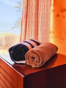 a couple of towels sitting on top of a dresser at Panorama Lodge Nuweiba in Nuweiba