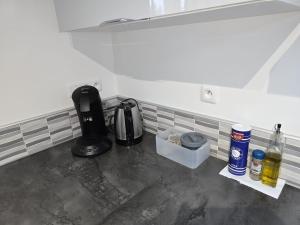 a kitchen counter with a coffeemaker and a coffee maker at Maison de la forêt in Dole
