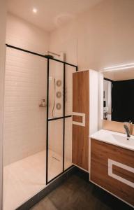 a bathroom with a shower and a sink at Ultimate Comfort ! Jacuzzi & Sauna. in Besançon