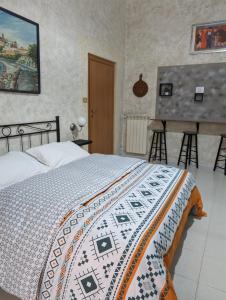 1 dormitorio con 1 cama y una pintura en la pared en B&B Il Geranio en Gaeta