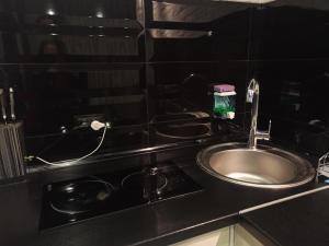 a kitchen with a sink and a counter top at Квартира с WiFi и видом на город и р Днепр in Kamianske