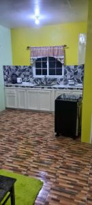 a kitchen with a counter top in a room at Mansfield Inn Ocho Rios in Ocho Rios