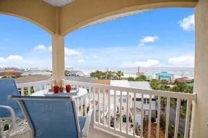 a balcony with a table and chairs and a view of the ocean at Casa Del Mar in Panama City Beach