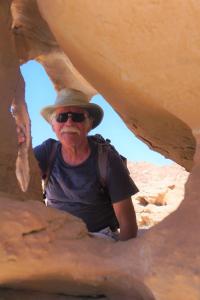 Um homem de chapéu e óculos de sol num desfiladeiro. em Mars moon camp em Wadi Rum