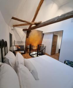 a bedroom with a white bed in a room at Duplex Luxe avec parking Sarlat centre in Sarlat-la-Canéda