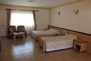 a hotel room with two beds and a window at Kaplica Hotel in Famagusta