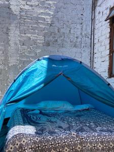 a blue tent sitting next to a brick wall at Home Sweet Home Guanajuato in Guanajuato