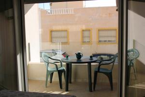 a table and chairs sitting on a balcony at Duplex Antonio Machado in Carboneras