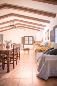 a dining room with two beds and a table at Casa Rural Mirador 1 in Bullas
