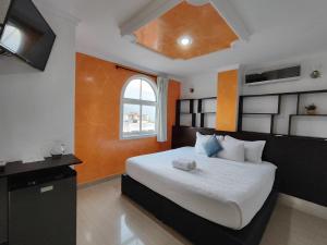 a bedroom with a bed with a teddy bear on it at HOTEL MILLA SUITES MERIDA in Mérida +32 photos