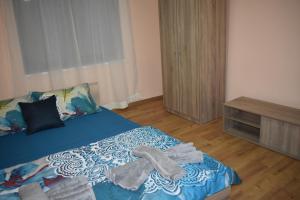 a bedroom with a bed with towels on it at Casa La Bunica in Orşova