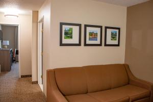 a living room with a couch and three pictures on the wall at Comfort Inn & Suites Geneva- West Chicago in Geneva