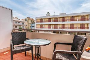 a patio with two chairs and a table on a balcony at City Life Marina apartment No.22 in Ampavris