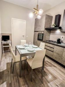 eine Küche und ein Esszimmer mit einem Tisch und Stühlen in der Unterkunft La Casa Bianca in Vercelli