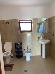a bathroom with a toilet and a sink at Bert-House close to the sea in Lezhë