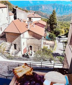 a plate of food with a view of a house at La Mansarda di Terelle in Terelle