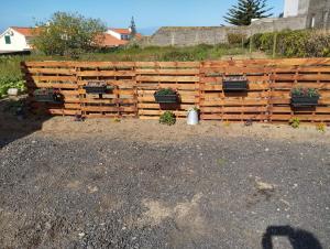 a wooden fence with potted plants on it at Casa do Lavrador in Ponta Delgada