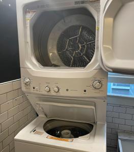 a washing machine with its door open in a bathroom at Chapter San Francisco in San Francisco