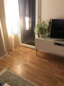 a living room with a flat screen tv on a dresser at 3 pièces avec belle terrasse et vue dégagée. in Suresnes