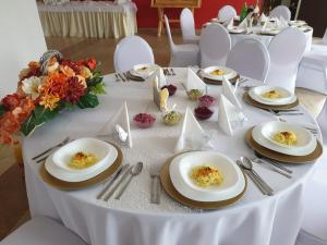 a white table with plates of food on it at Ośrodek Natura Fizjo Med & SPA in Jarnołtówek