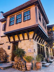 a building with potted plants in front of it at Aristotelous Alexandrou Historic Inn in Arnaia