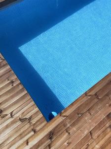 a close up of a swimming pool on a wooden floor at Minimal Cream Apartment Pool-front in Paros in Parikia