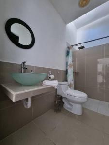 a bathroom with a sink and a toilet at Melaque Rent House 1 in San Patricio Melaque