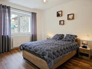 Un dormitorio con una cama grande y una ventana en Appartement 2 chambres aux pieds des Vosges, en Abreschviller