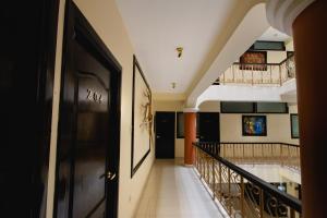 a hallway with black doors and a staircase in a house at TerraMistica - Puno Centro in Puno