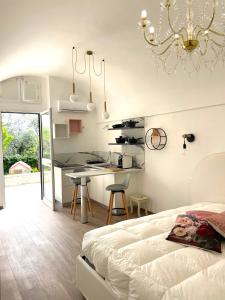 a bedroom with a bed and a kitchen with a table at B&B Case Vacanza Orchidea marina di Macchia a Mattinata Gargano in Monte SantʼAngelo +73 photos