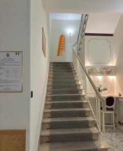 a staircase in a building with a chair at Hotel La Pace in Pontedera